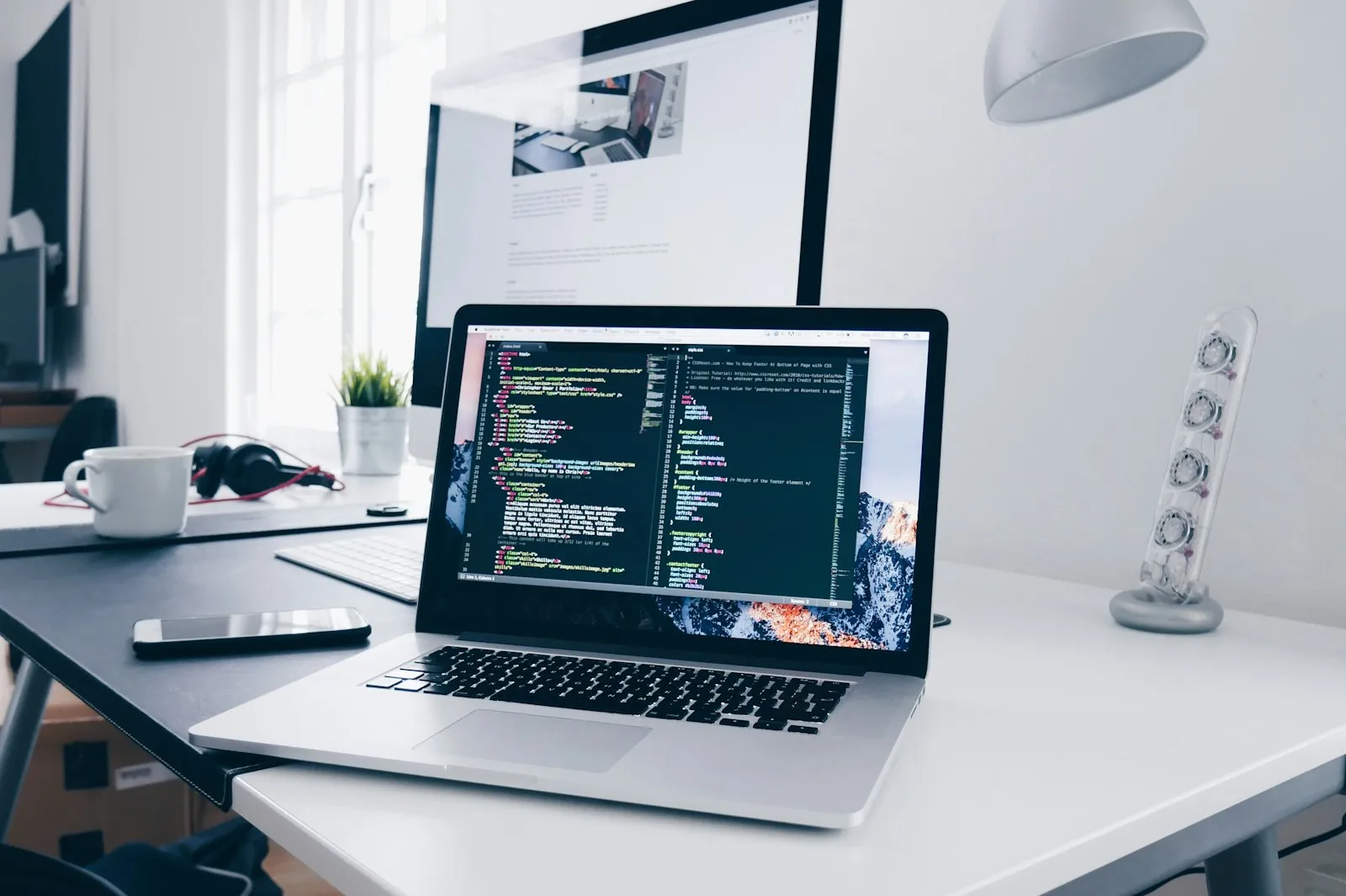Developer writing code on a laptop